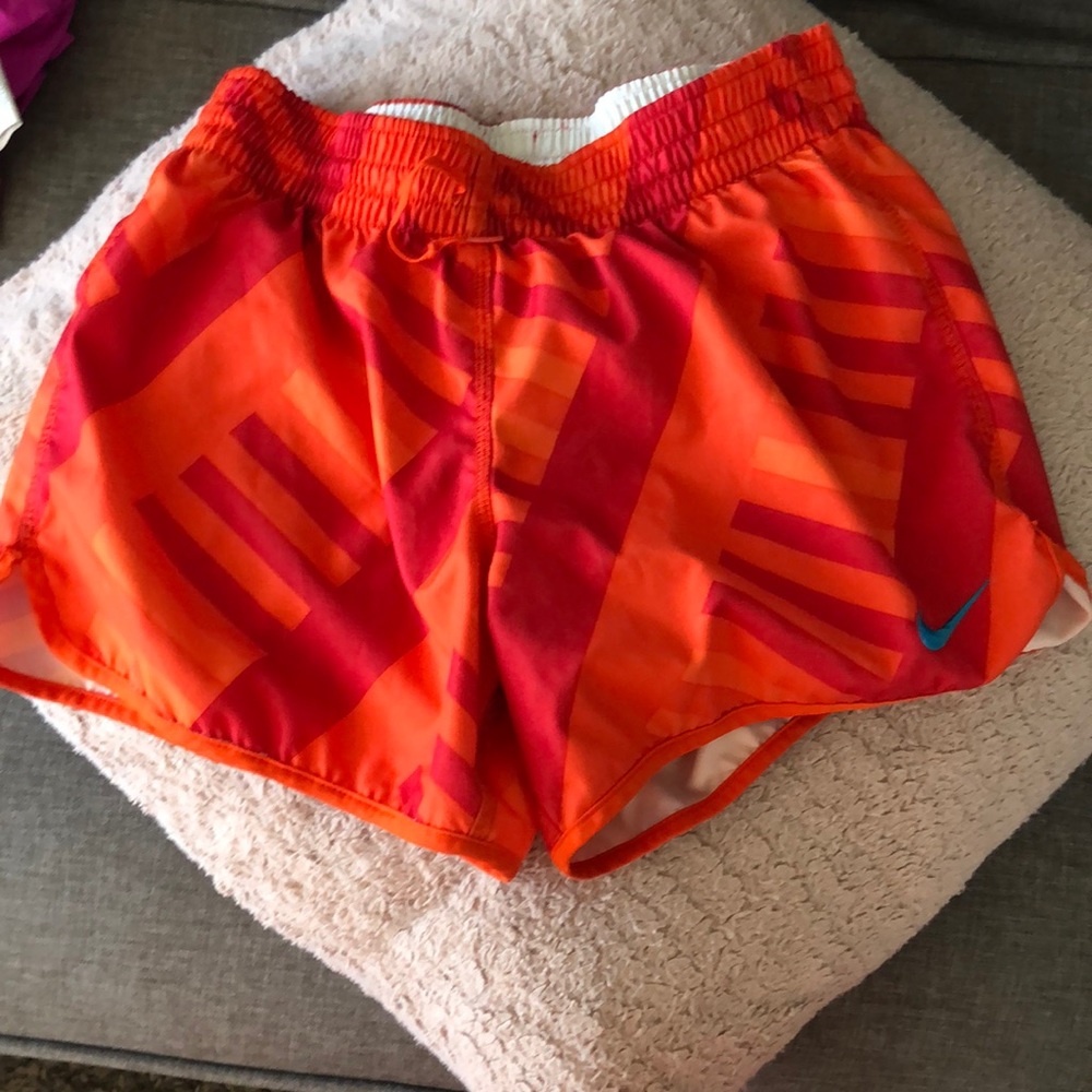 Orange Nike running shorts